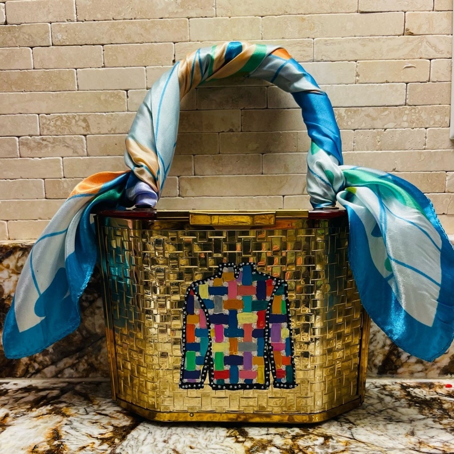 lucite purse in gold basketweave with lucite handles and top lid.