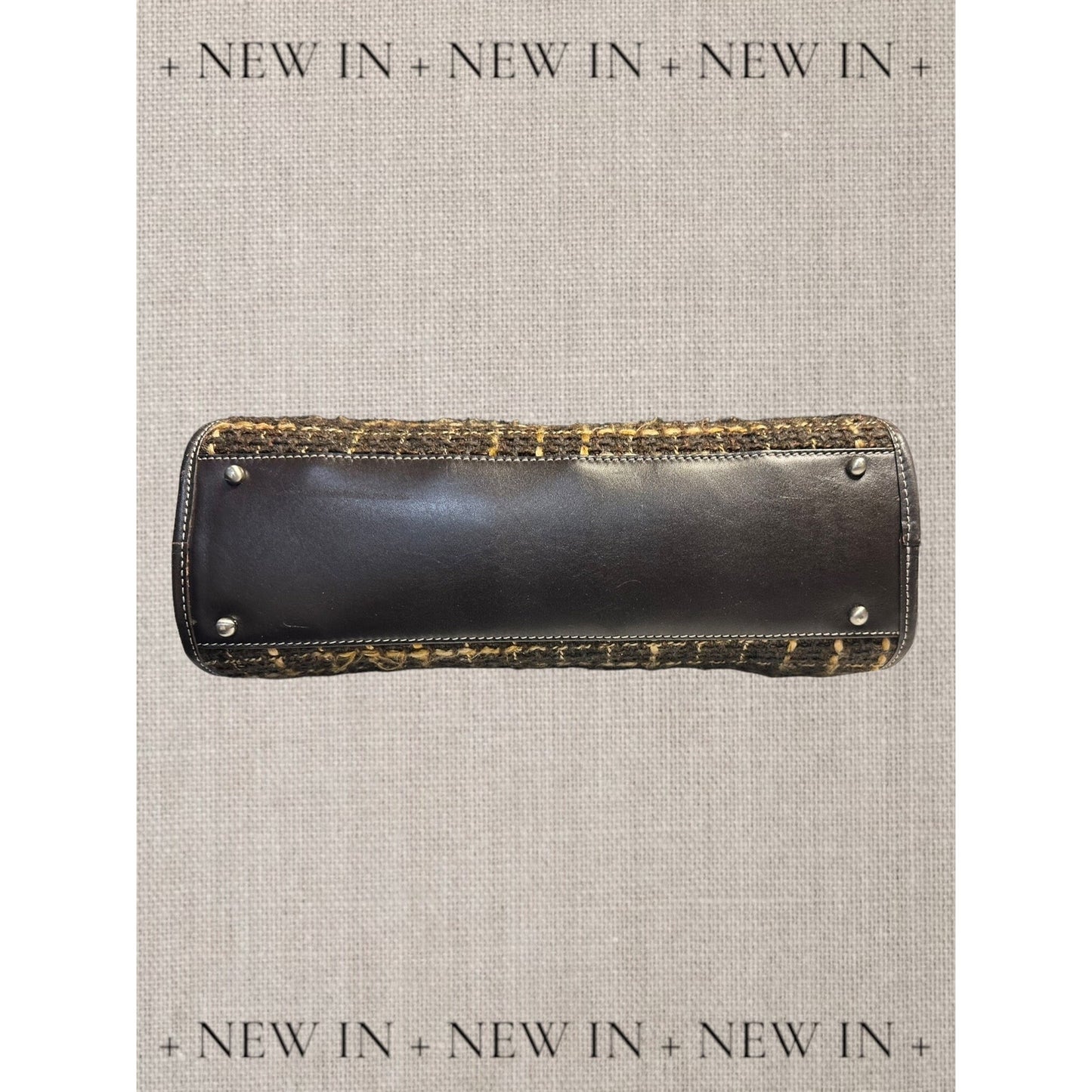 Jones New York leather lambswool and man made elements and a helmet embellished on a canvas appliqué.
