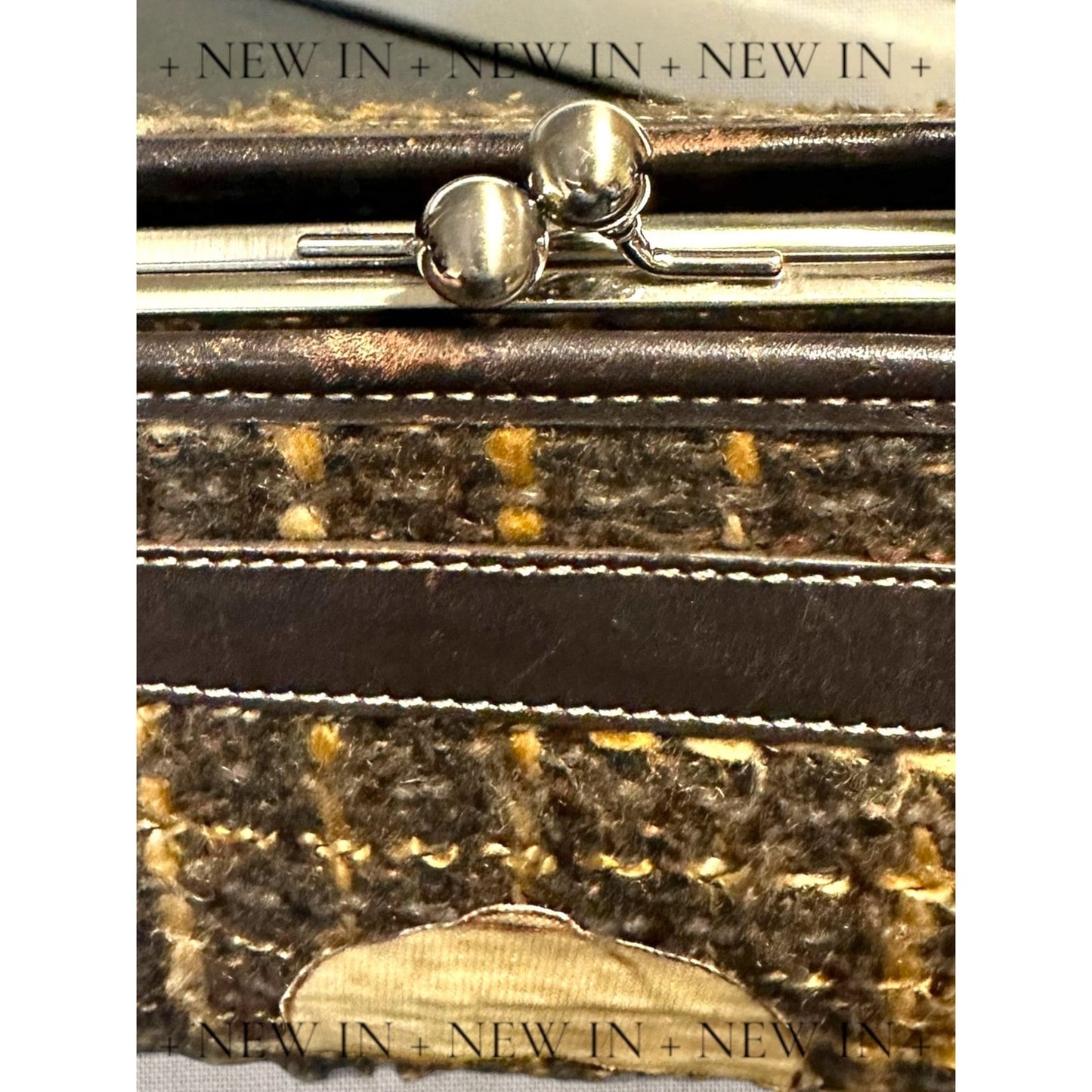 Jones New York leather lambswool and man made elements and a helmet embellished on a canvas appliqué.