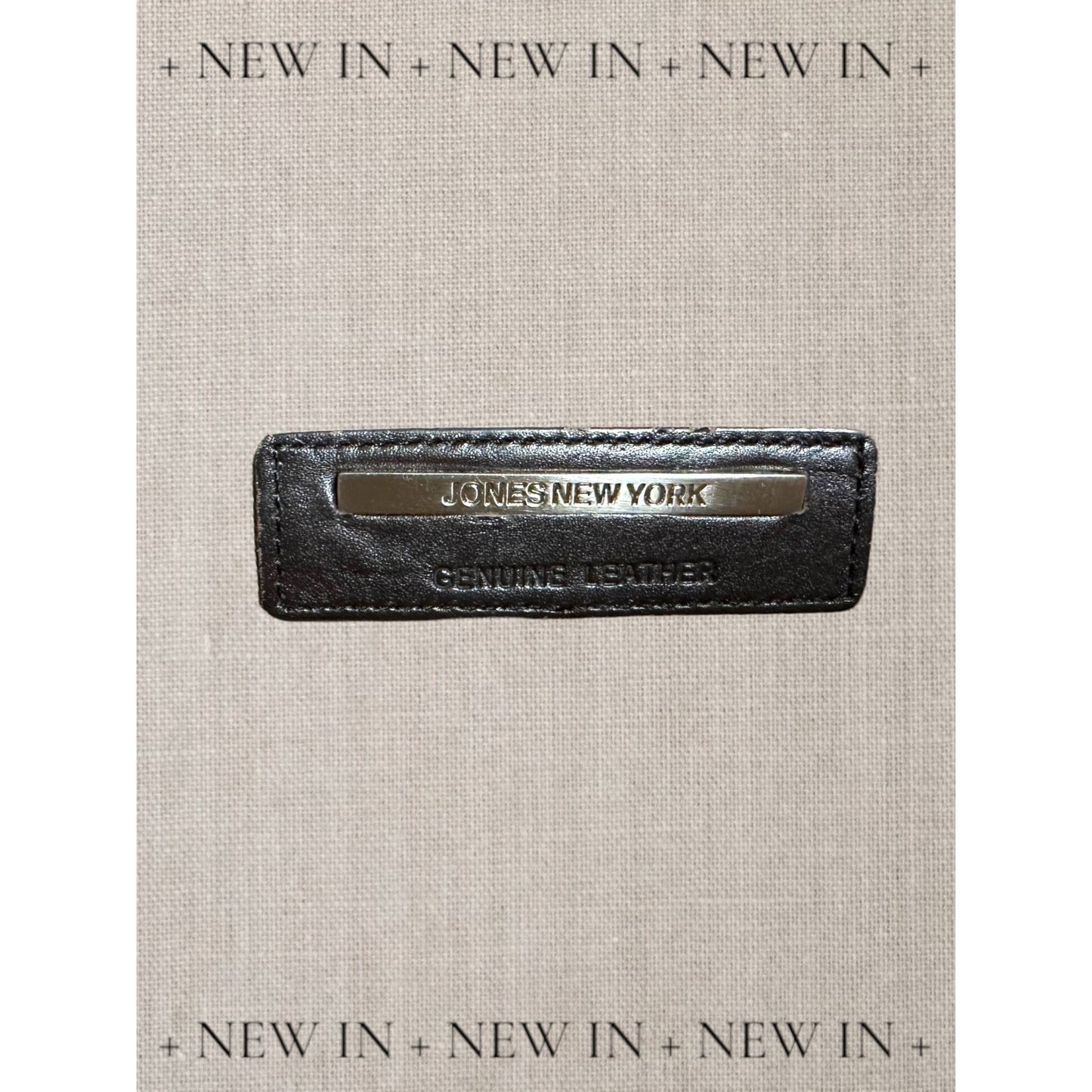 Jones New York leather lambswool and man made elements and a helmet embellished on a canvas appliqué.