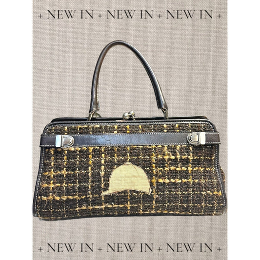 Jones New York leather lambswool and man made elements and a helmet embellished on a canvas appliqué.